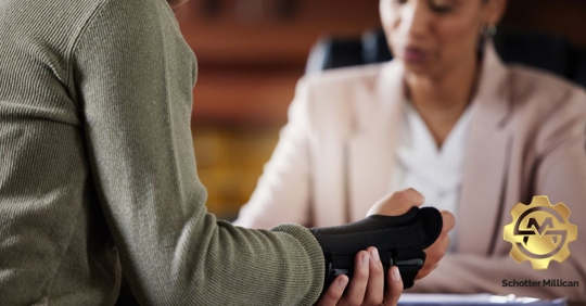 Individual with a wrist brace on talking to another person