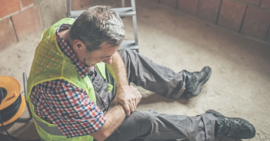 injured worker holding wrist