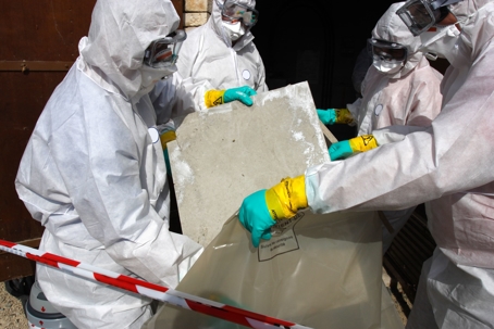 workers throwing out asbestos tiles
