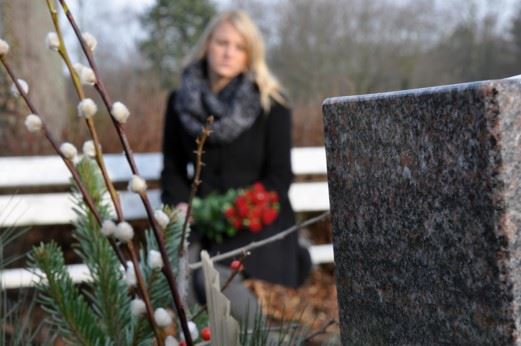 woman standing at graveside